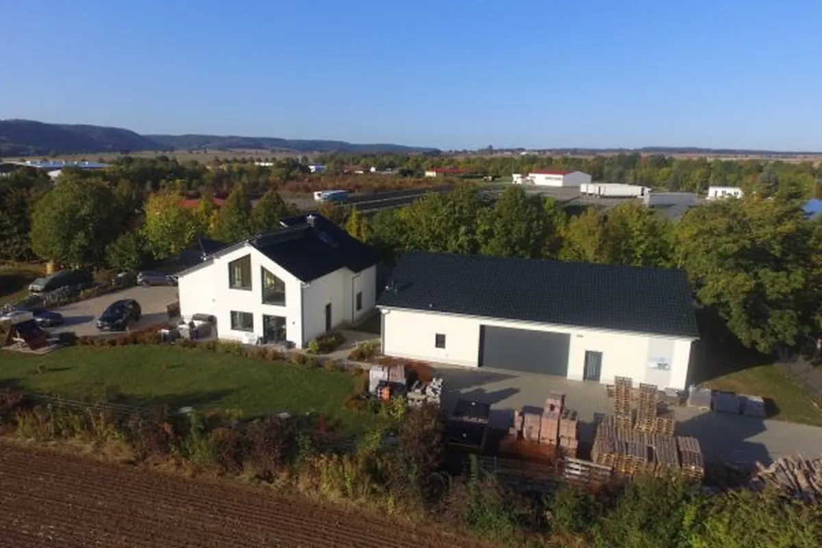 Luftaufnahme eines weißen Einfamilienhauses im Neubaugebiet